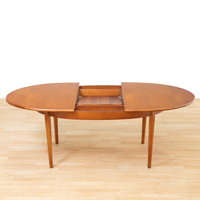 This vintage mid-century extending dining table was produced by Jentique in the 1960s. Made of teak, this extending dining...