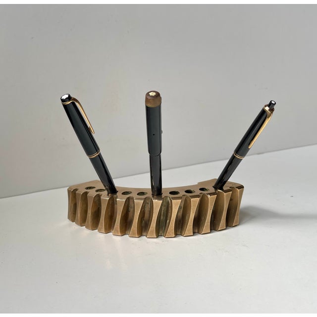 An artist made pen holder in heavy stock solid bronze. This is number 1 of 33 made. This very interesting and brutalist'...