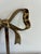 A charming vintage wall hook cast in solid brass in the shape of a bow, with looped ribbon ends and a knotted center...