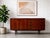 Mid Century Modern Rosewood Credenza, Made in Denmark, c. 1960’s. Beautifully proportioned and crafted in richly figured...