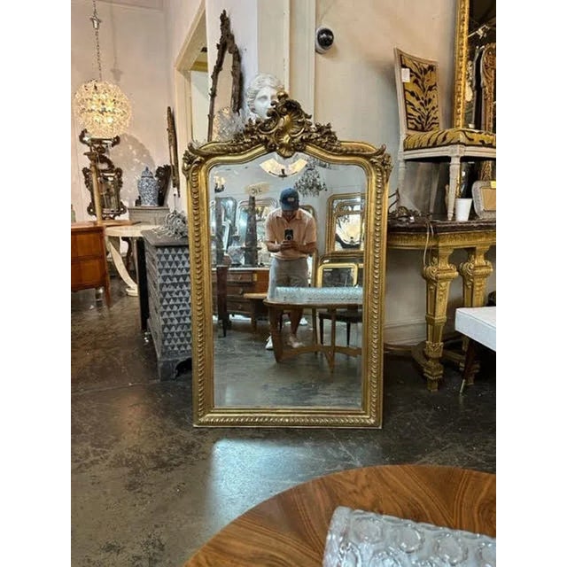 Gorgeous 19th century French Louis XV carved and giltwood mirror. Featuring an elaborate crest at the top. Very fine...