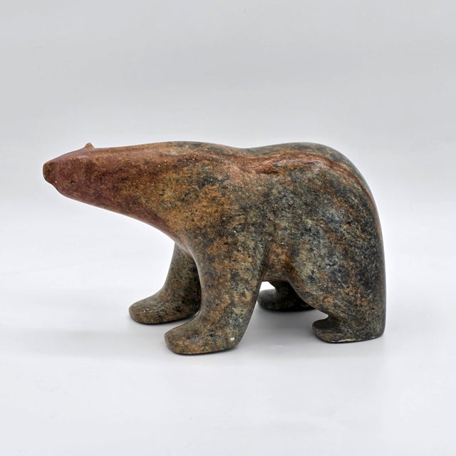 A substantial carved stone bear sculpture signed C. Olivier and dated 1998. The piece has a simplified modernist animal...