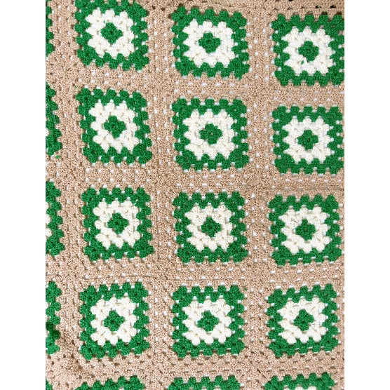 A beautifully handcrafted vintage crochet blanket featuring classic granny square construction in a timeless green, cream,...