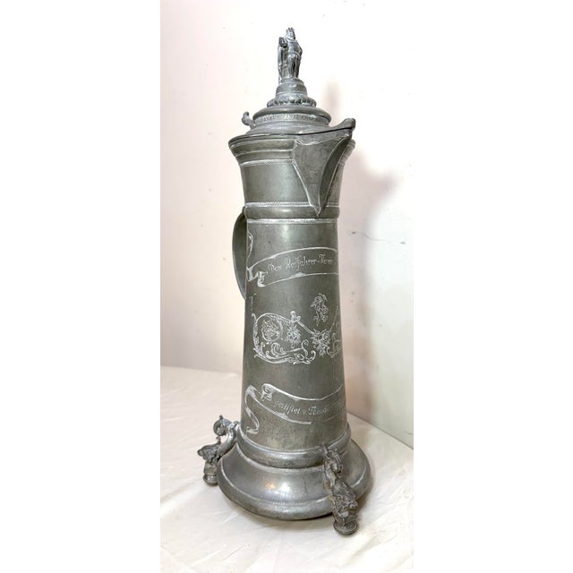 This large antique German cycling trophy award pewter lidded tankard is a unique and collectible piece that showcases the...