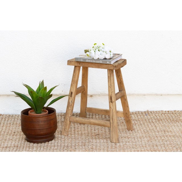 Full of age and character, this farmhouse style joint stool has a weathered look. This antique Asian stool has a stretcher...