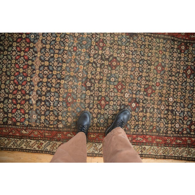 :: A Lori Qashqai weaving with an allover covered field in a repeating central floral design and minor, simplistic...