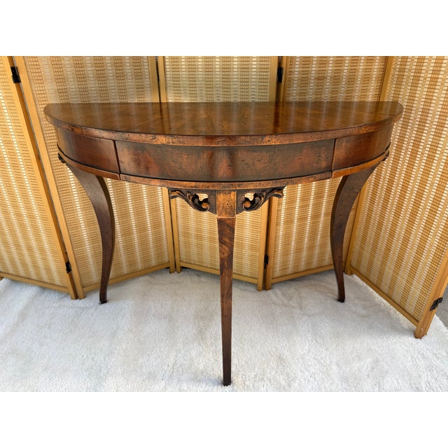 Exhibiting the pinnacle of Italian artisanal craftsmanship, this exquisite neoclassical demilune console table is from...