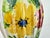 A lively hand-painted Italian ceramic vase featuring bold, expressive florals in sunlit yellow and deep red, accented with...