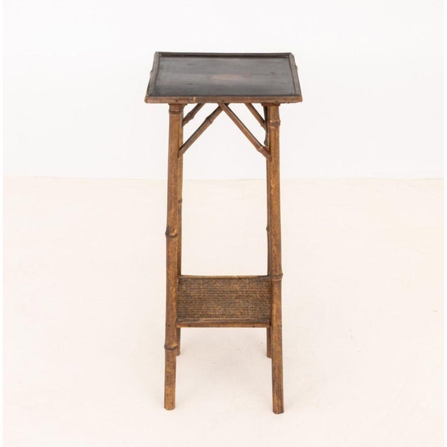 Aesthetic Movement Two-Tier Bamboo Side Table, with black and red lacquered japanned top above woven rattan undertier....