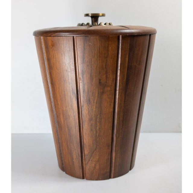 We are selling this simple and stylish Mid-Century modern ice bucket by Vermilion. This ice bucket has body of walnut with...