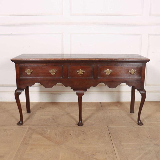Small 18th Century English oak cabriolet leg dresser base. This piece is designed in the style of the selected designer...
