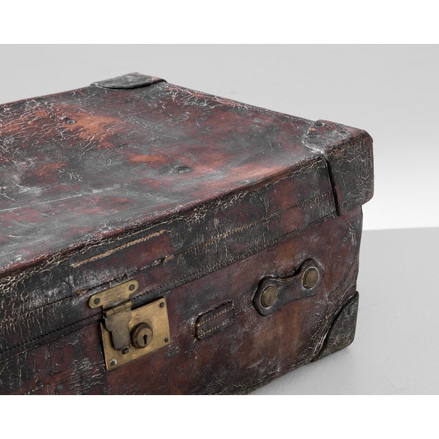 Step back in time with this captivating 1900s Central European Leather Suitcase, a stunning relic of vintage travel charm...