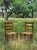 A Pair of Antique Primitive Ladderback Roped Seat Folk Art, Farm Chairs, Early 1900s. The color is a rich deep...