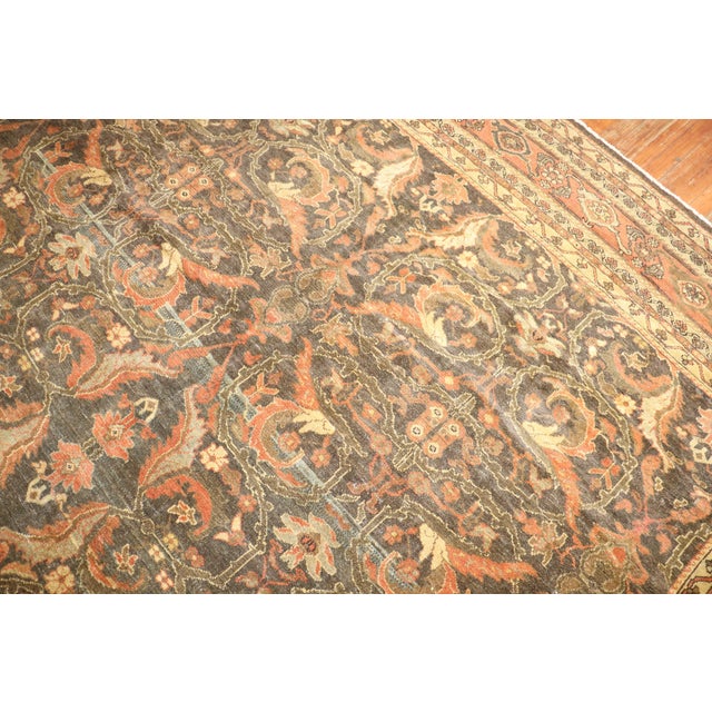 An early 20th century room size Malayer rug with dominant shades in brown and orange Measures: 10'8'' x 13'4''.