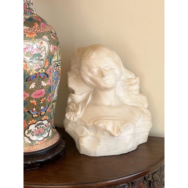 An Italian artist signed 19th century marble bust of a lady. Wearing a ruffled top with a veil partially covering her...