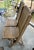 Vintage double folding theater-style bench crafted from solid wood with a slatted seat and back design. This rustic piece...