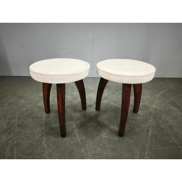 A refined pair of Art Deco stools from the 1940s, crafted from solid beech wood and recently reupholstered in a neutral...