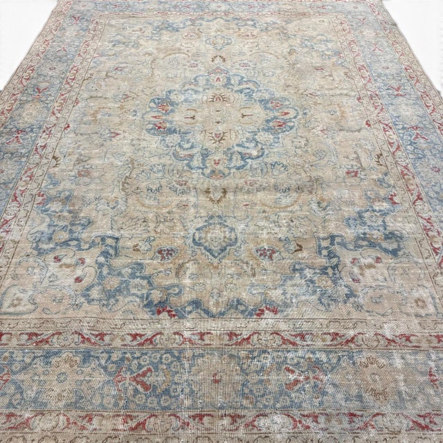 This antique Meset rug features a finely detailed central medallion surrounded by a rich composition of floral motifs. Set...