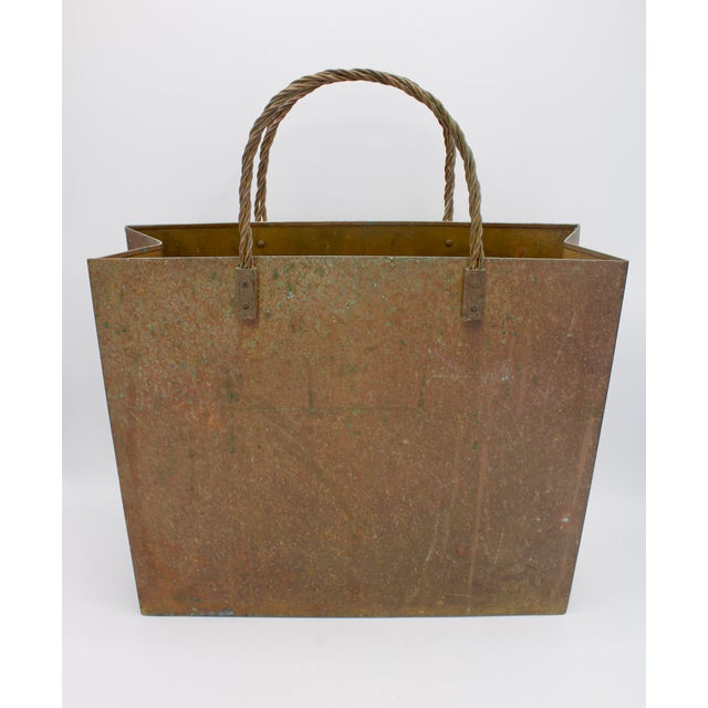 A superb mid century modern brass tote magazine rack, circa 1940s. Lovely verdigris patina.