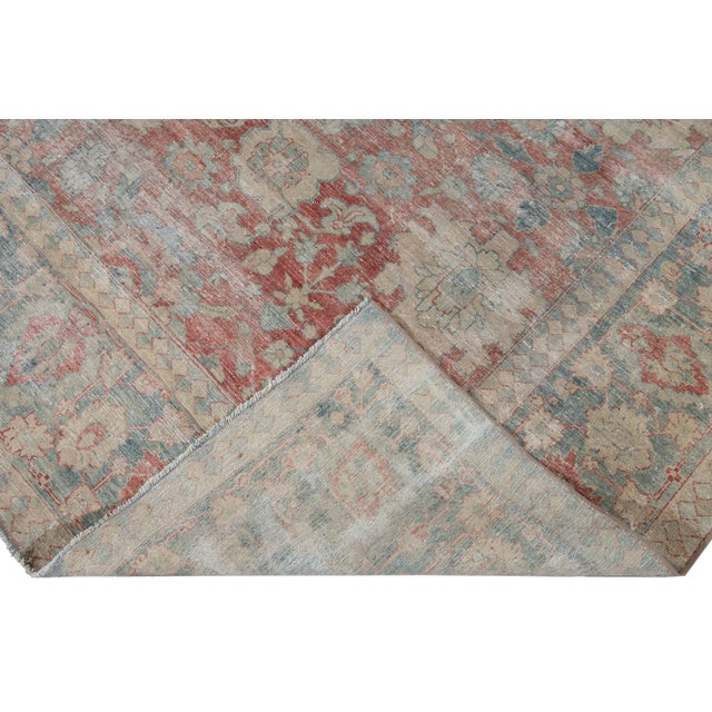 Beautiful antique Mahal hand-knotted wool rug with a red field. This Mahal rug has a blue frame beige and peach accents in...