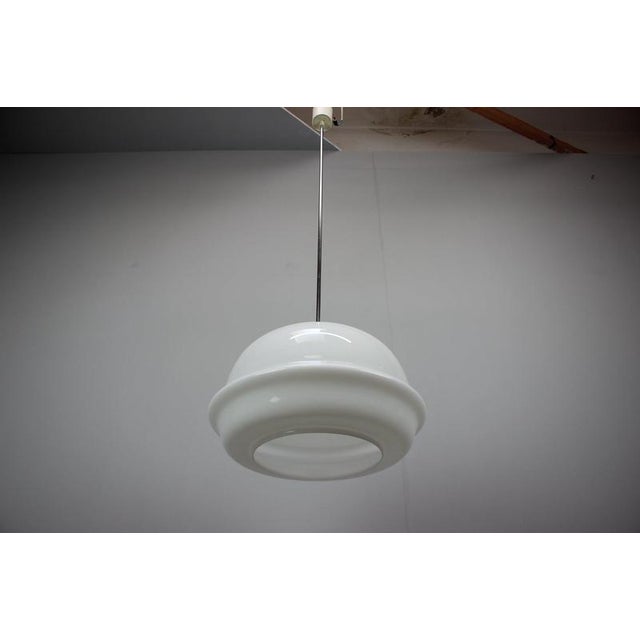 Original 1970s pendant lamp from Czechoslovakia, manufactured in Valašské Meziříčí. The lamp features a distinctive...