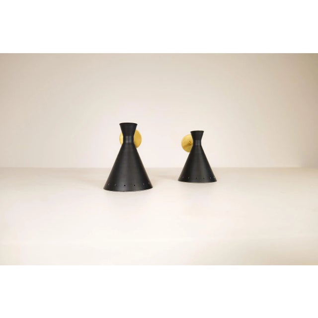 Pair of modern italian wall lights. Also, could be used as a bedside sconce. Made with brass and painted sheet metal....