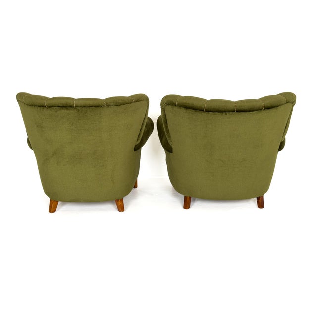 A beautifully sculptural pair of Swedish Modern lounge chairs produced in Sweden during the 1940s. Defined by their...