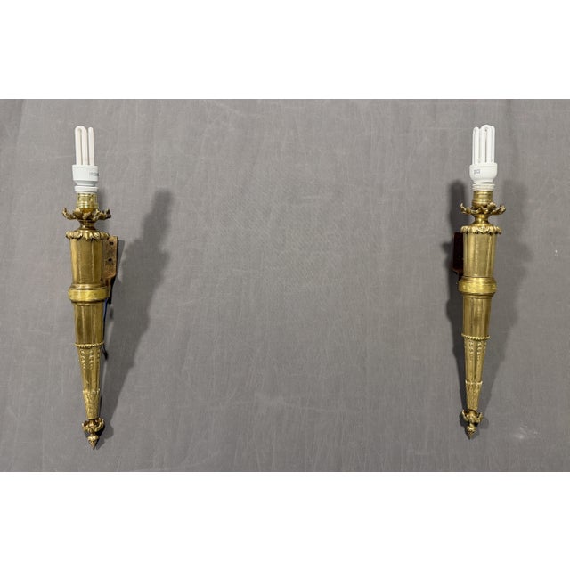 Wall sconces. Torches. Louis XVI style, early 19th century. Made of bronze. Interior markings: JL 48 (not visible)....