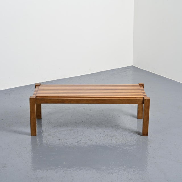 Modernist coffee table in solid wood, circa 1960, remarkable for the graphic construction of its tabletop. The tabletop is...