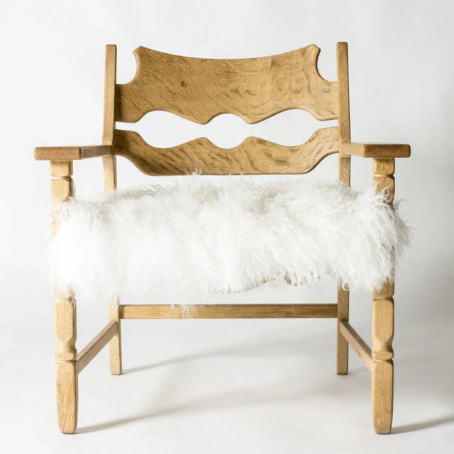 Cool “Razorblade” lounge chair by Henning Kjaernulf, in a rustic meets modernism design. Made of oak with beautiful wood...