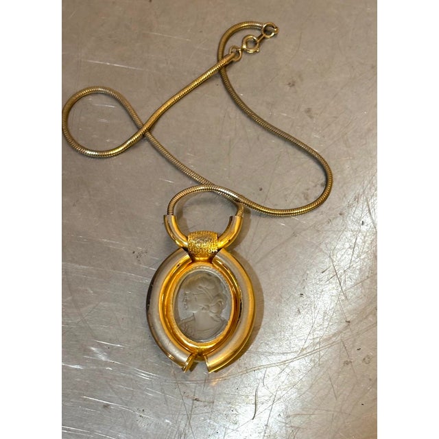 1970s-80s gold-tone/carved lucite cameo pendant necklace. Excellent condition.