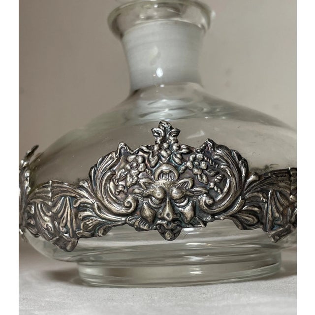 This large antique scent bottle is a true collector's item. Made with sterling silver mounted over glass in high relief it...