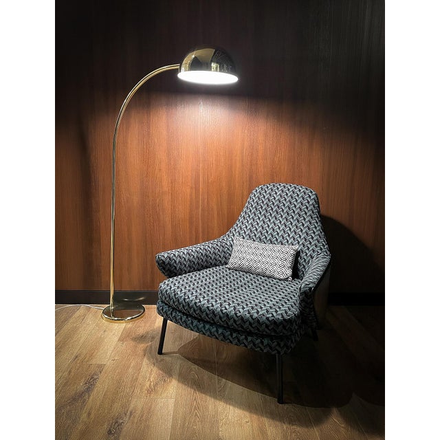 Striking vintage circa-1970s arc floor lamp featuring an exceptionally slender, sweeping profile in a polished brass...