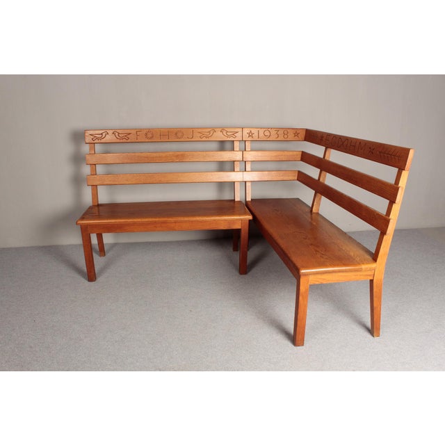 Solid oak, brown stained. Personalized corner bench with Christian symbolism, made in southern Germany in the 1930s. The...