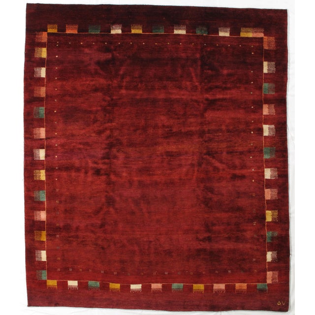 Vintage hand-knotted Persian Lori Gabbeh rug featuring a rich, saturated field framed by a decorative border with...
