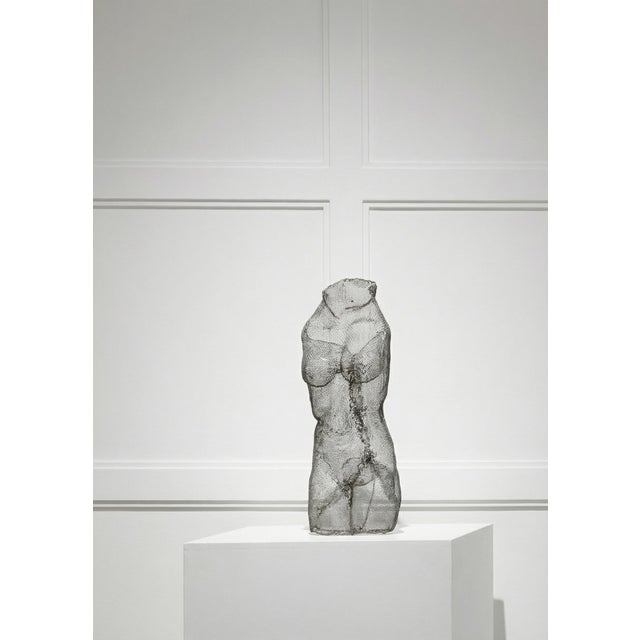 Striking vintage sculpture crafted from fine wire mesh, depicting an abstract nude female form. The translucent quality of...
