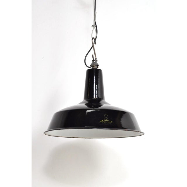 Beautiful black enamelled lamps from the 1950s. The attractive yellow logo of the belgian company reluma is still visible....