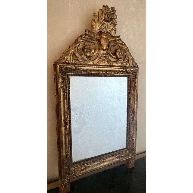 Antique French bridal mirror, hand carved wood top with a design of leaves, flowers and a heart in the center. The glass...