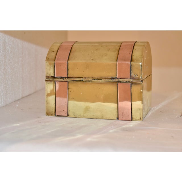 Late 19th century brass box from England. The box is in the form of a travel trunk with a domed lid and applied brass...