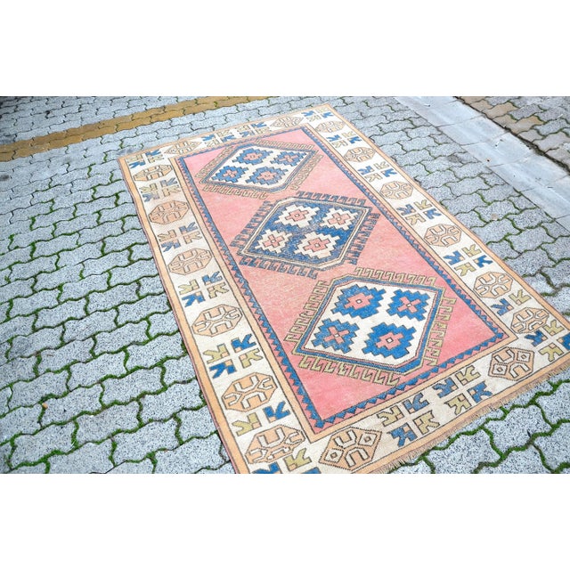 This is a vintage Turkish Oushak rug from the 1960s. The piece was hand-knotted.