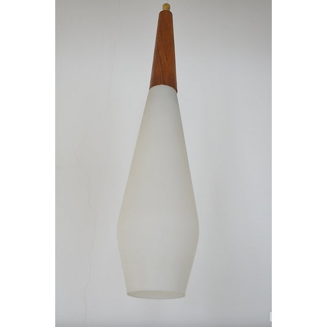 Scandinavian opal glass pendant lamp from the 1960s. - Opal glass cylinder - E14 socket - ​​Walnut wood part Up to 250V...