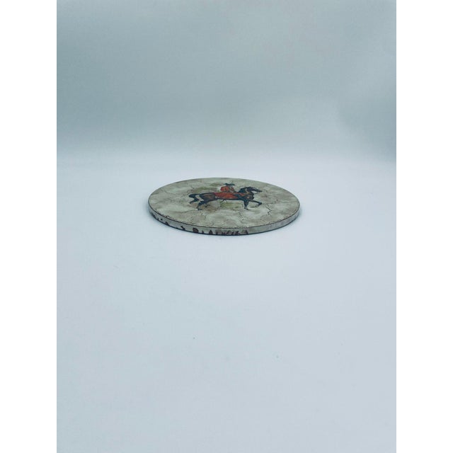 A decorative wall plate of Italian origin, crafted from high-quality ceramic. The plate features a distinctive structure...