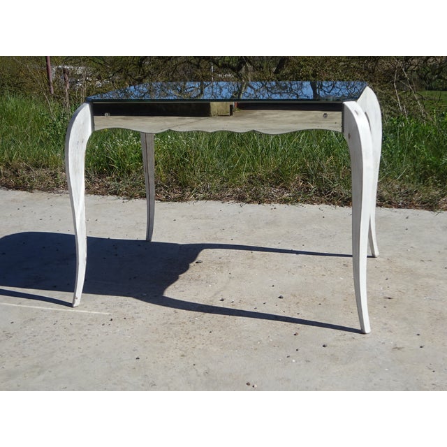 Neoclassical style coffee table. Made in the 1950s. Solid wood frame, covered with mirrored glass on the top and sides....