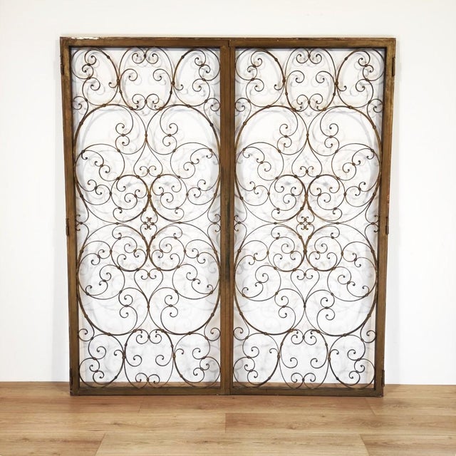 An elegant double-leaf partition door, crafted entirely from wrought iron and featuring refined craftsmanship. The design...