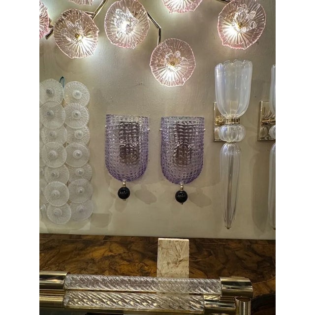 Decorative pair of lavender sconces with black ball. These glistening beauties that create a beautiful impact. So pretty!...