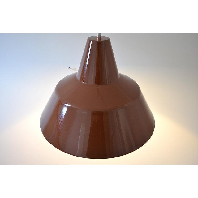 Enamelled work lamp by Louis Poulsen from the 1960s, chocolate brown exterior, white enamelled metal interior. Textile...