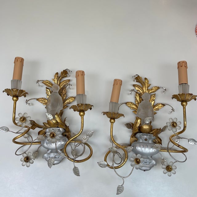 A pair of frosted glass and gilt metal wall sconces with foliate designs featuring crystal vases and frosted glass Asian...