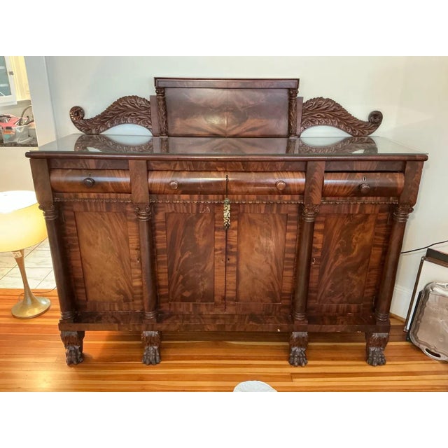 Statement American Empire (Classical) sideboard in richly figured flame mahogany, with dramatic book-matched veneers...