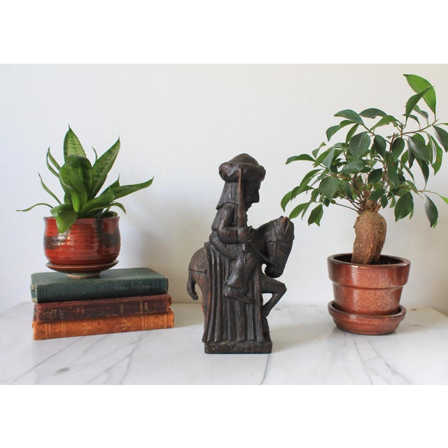 Vintage hand-carved wooden folk art sculpture depicting a figure wearing turban-like head covering while riding a donkey....