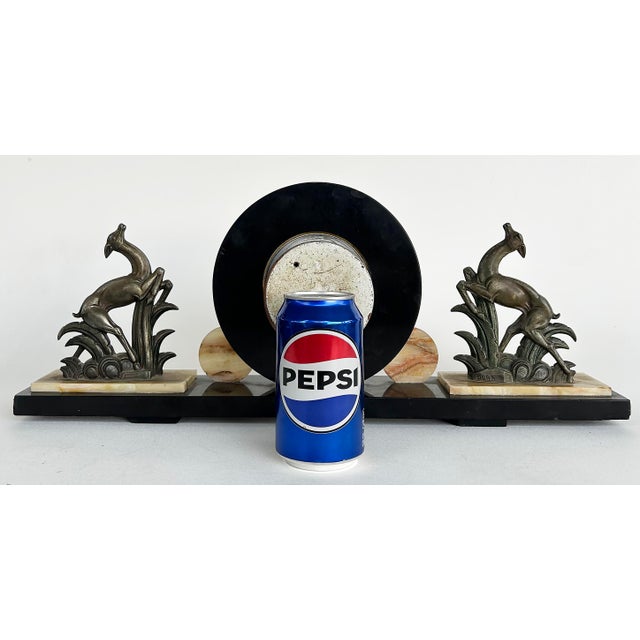 French Art Deco Marble Onyx Mantel Clock with Gazelles Signed Ucra 1930s Offered for sale is a French Art Deco marble and...